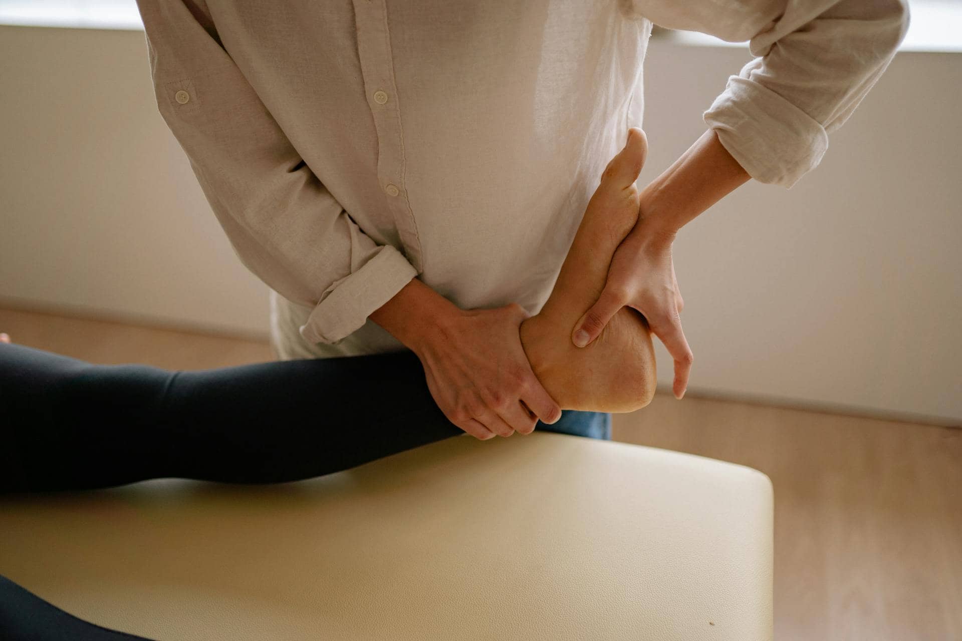 A man massaging a client’s foot