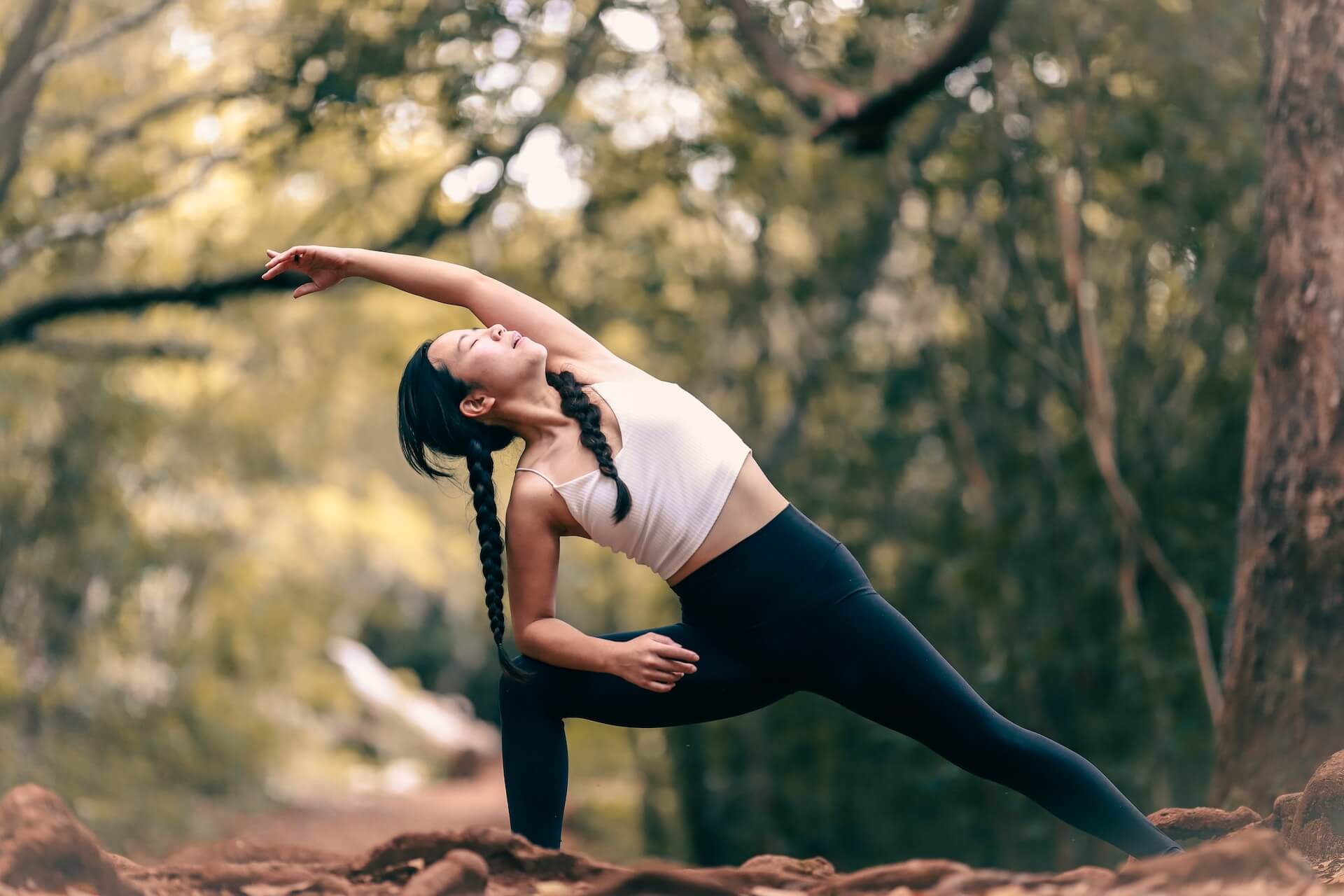 woman doing yoga in the forest